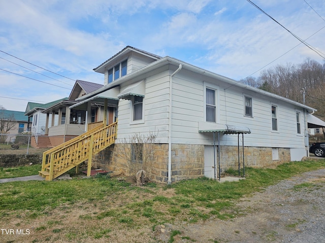 view of side of property with stairs