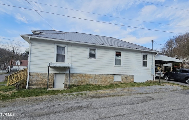 view of home's exterior with a carport and metal roof