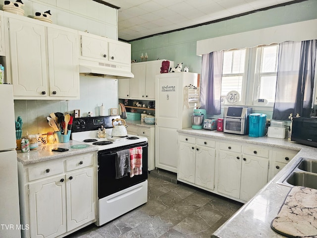 kitchen with under cabinet range hood, white appliances, white cabinets, and light countertops