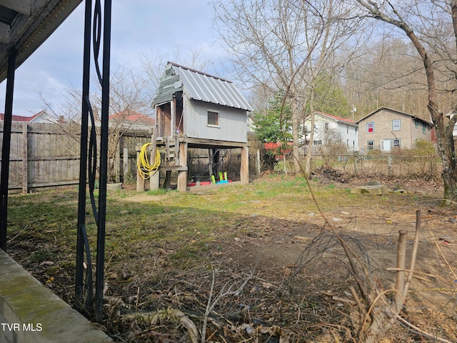 view of yard with an outdoor structure and a fenced backyard