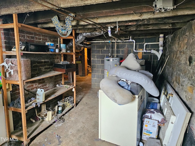 unfinished basement featuring electric water heater and concrete block wall