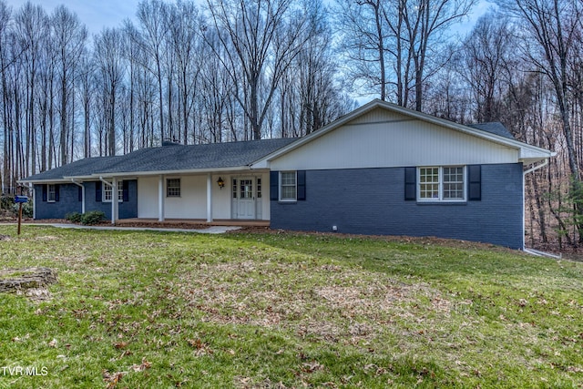 single story home with brick siding, covered porch, and a front yard