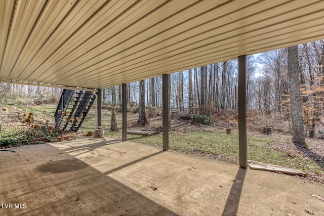 view of patio / terrace featuring stairway and a carport