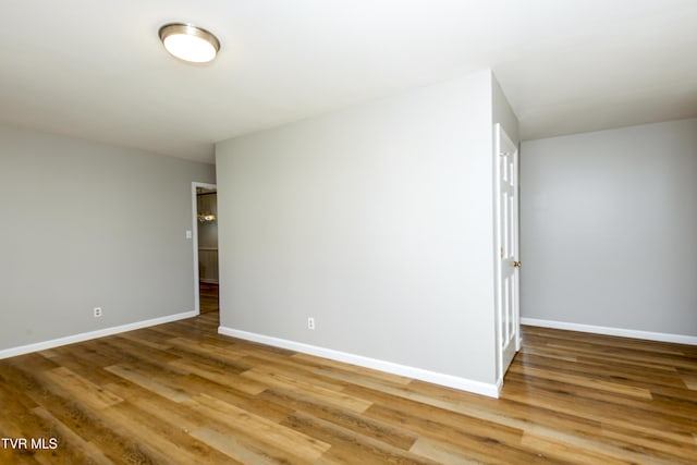 empty room with baseboards and light wood finished floors