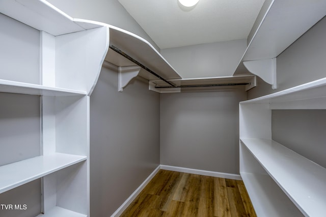 walk in closet featuring wood finished floors