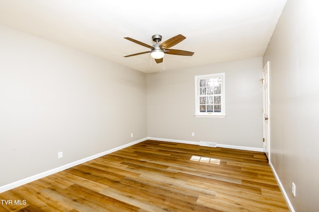 unfurnished room featuring visible vents, baseboards, light wood-style floors, and a ceiling fan