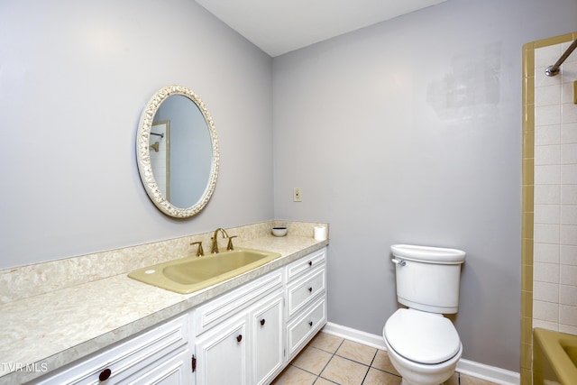 bathroom featuring baseboards, toilet, vanity, and tile patterned flooring