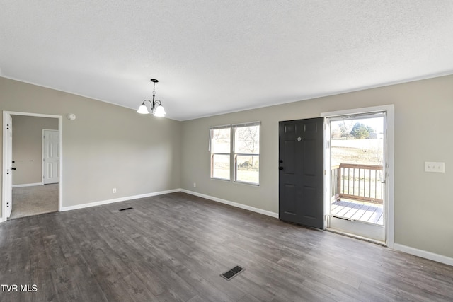 entryway with visible vents, plenty of natural light, a chandelier, and dark wood-style flooring