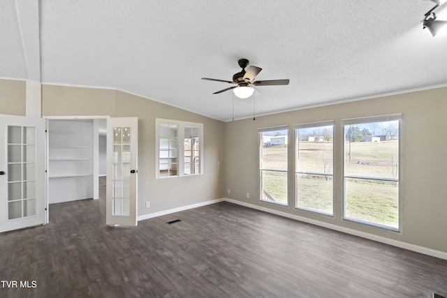 unfurnished living room with french doors, dark wood-type flooring, baseboards, and vaulted ceiling