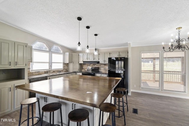 kitchen with visible vents, electric range, freestanding refrigerator, a sink, and butcher block counters