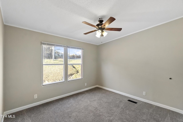 unfurnished room featuring baseboards, visible vents, dark colored carpet, and ceiling fan