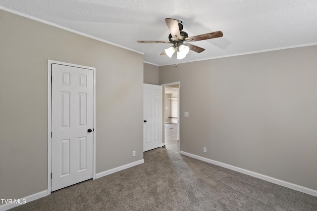 unfurnished bedroom with a ceiling fan, baseboards, a textured ceiling, crown molding, and carpet flooring