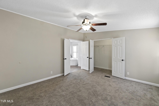 unfurnished bedroom with a closet, baseboards, carpet floors, and a textured ceiling