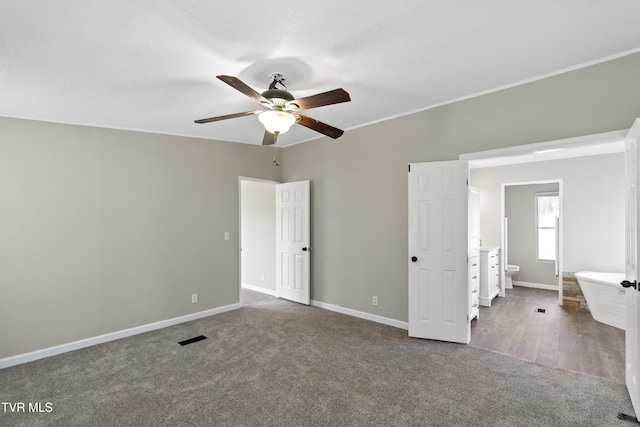 unfurnished bedroom with carpet, visible vents, baseboards, ceiling fan, and a textured ceiling