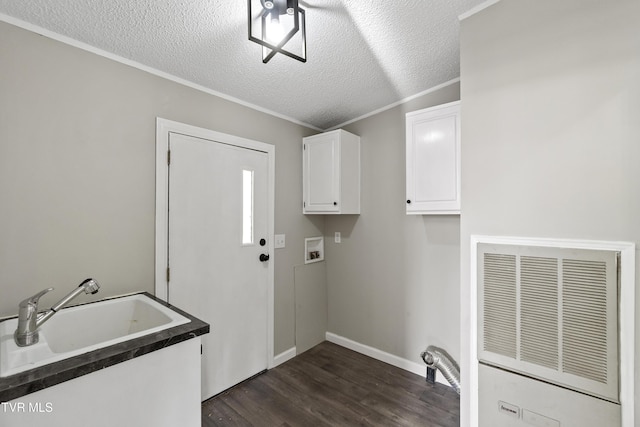 laundry area featuring hookup for a washing machine, cabinet space, dark wood-style flooring, a heating unit, and a sink