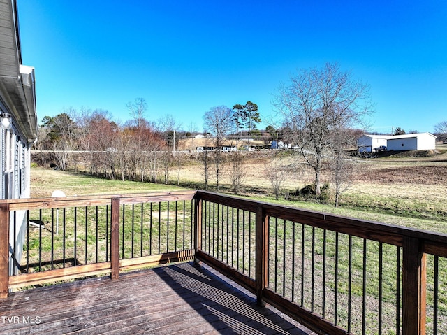 wooden deck featuring a yard