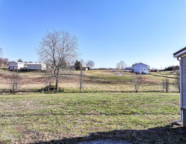 view of yard with a rural view