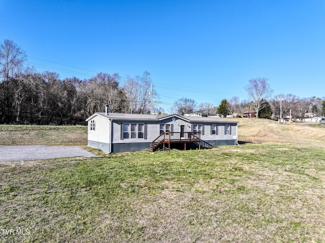 manufactured / mobile home featuring crawl space, a deck, stairway, and a front yard