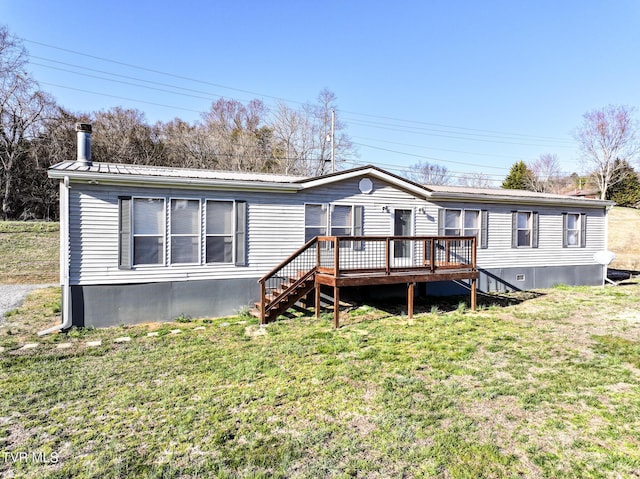 manufactured / mobile home featuring a deck, a front yard, crawl space, and metal roof