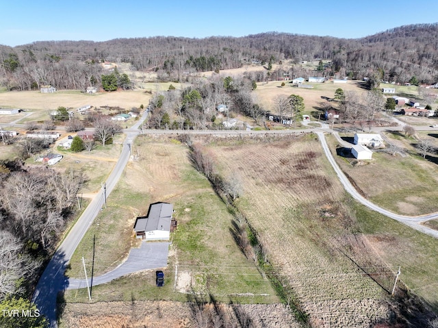 aerial view featuring a rural view and a wooded view