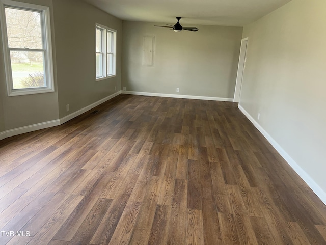 unfurnished room featuring baseboards, a ceiling fan, and dark wood-style flooring