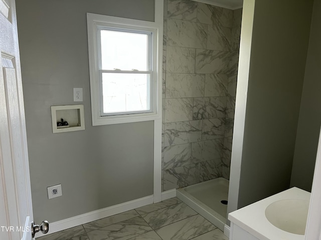 bathroom featuring baseboards, marble finish floor, and a shower stall