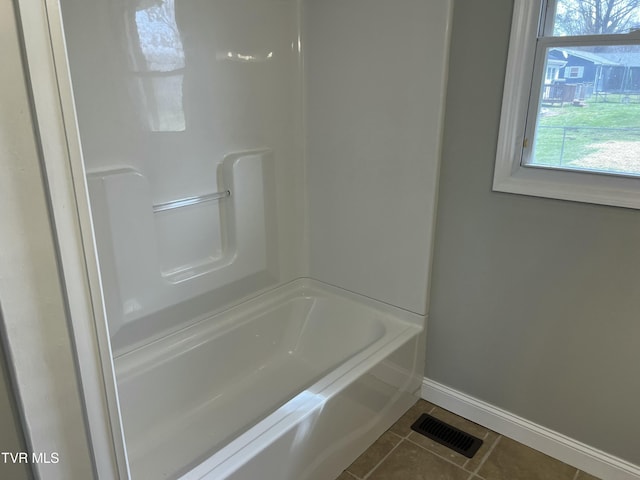 full bath featuring tile patterned flooring, visible vents, baseboards, a bathing tub, and a shower