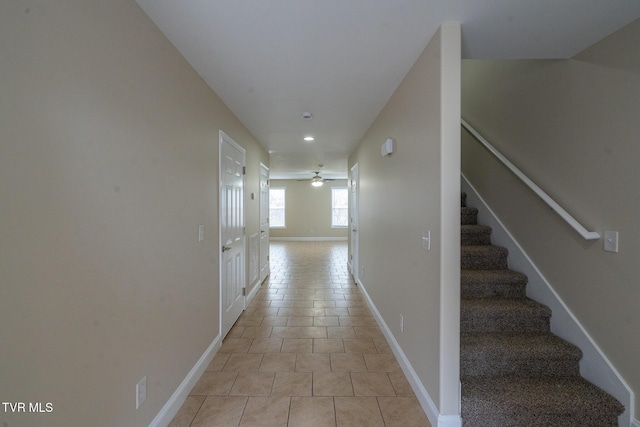 hall featuring stairs, light tile patterned flooring, recessed lighting, and baseboards