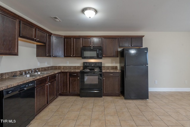 kitchen with dark countertops, visible vents, dark brown cabinetry, black appliances, and a sink