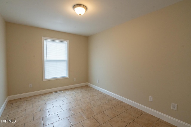 unfurnished room with visible vents and baseboards