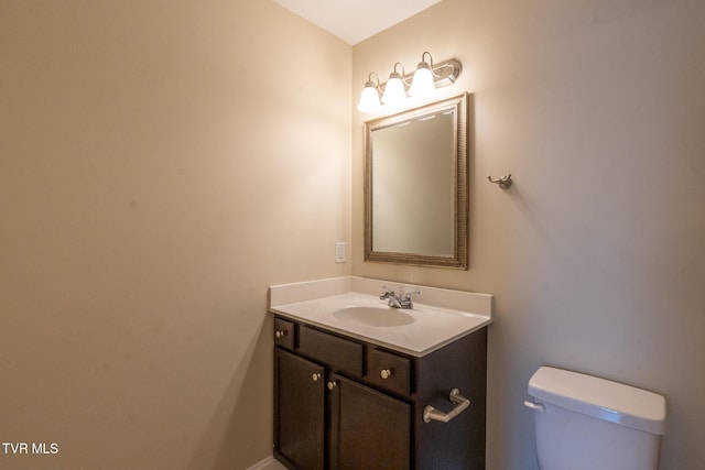 half bathroom featuring toilet and vanity