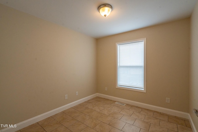 spare room with visible vents and baseboards