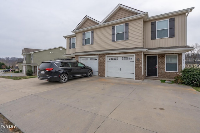 view of front of home with brick siding, an attached garage, and driveway