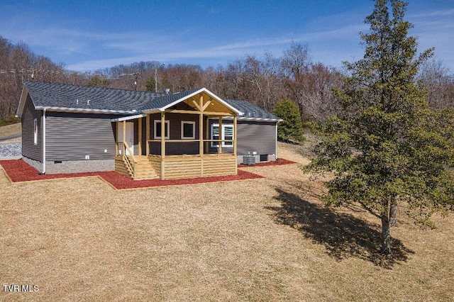 rear view of property with crawl space and a porch