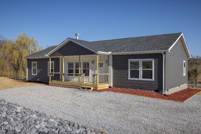 view of front of house with crawl space, a porch, and roof with shingles