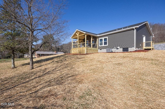 back of property with crawl space, a porch, and central AC