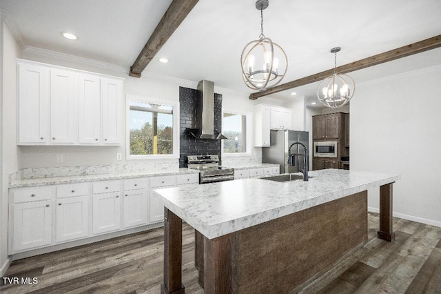 kitchen featuring beamed ceiling, appliances with stainless steel finishes, a notable chandelier, wall chimney exhaust hood, and a sink