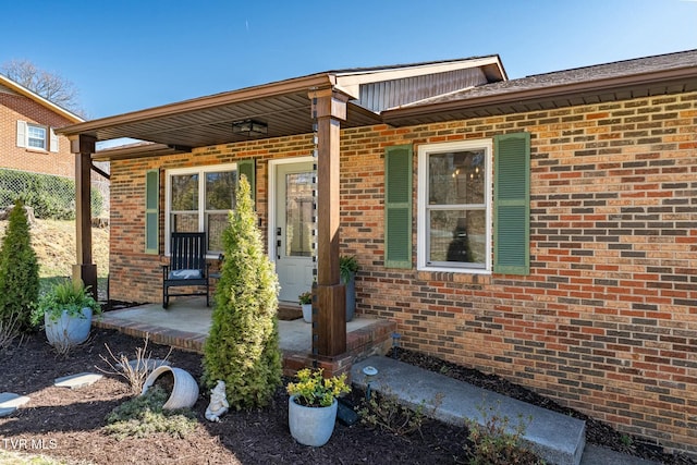 entrance to property featuring brick siding