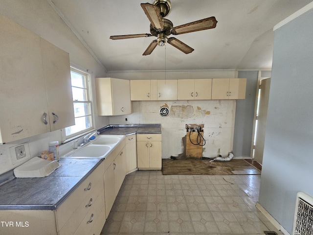 kitchen featuring visible vents, ceiling fan, light floors, ornamental molding, and a sink