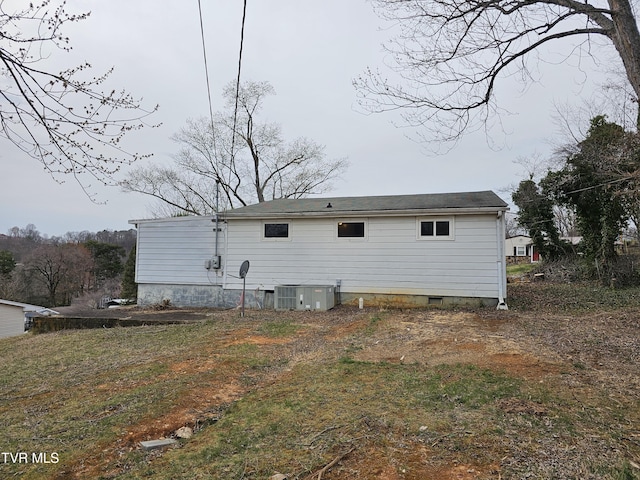 rear view of property featuring crawl space and central air condition unit