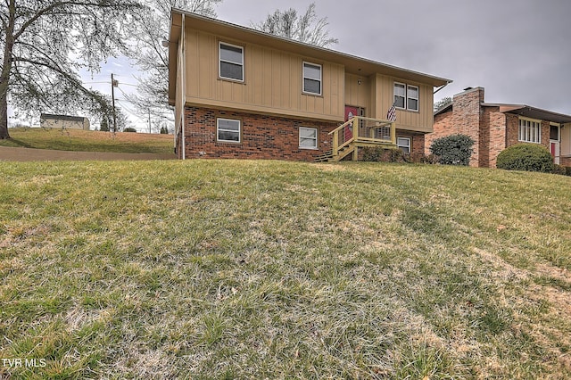 exterior space featuring brick siding and a front yard