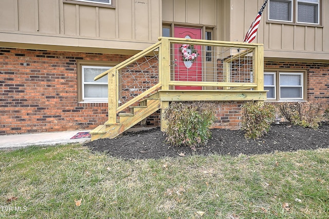 property entrance featuring brick siding and board and batten siding