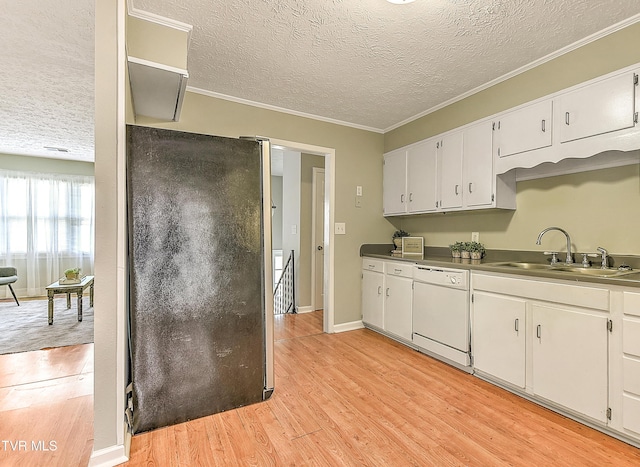 kitchen with white cabinetry, freestanding refrigerator, a sink, dishwasher, and light wood-type flooring