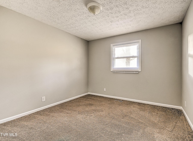 unfurnished room featuring a textured ceiling, baseboards, and dark colored carpet