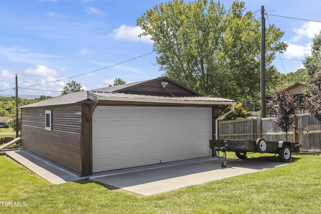 detached garage featuring fence