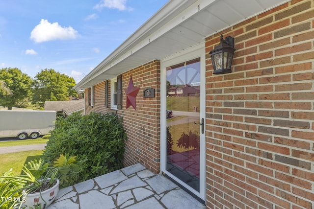 property entrance with brick siding