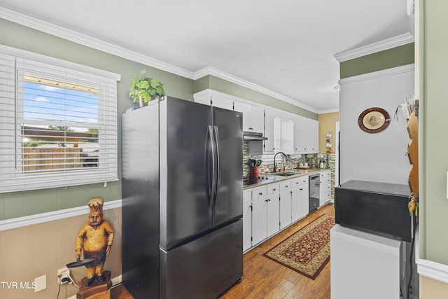 kitchen featuring white cabinetry, dishwashing machine, crown molding, and freestanding refrigerator