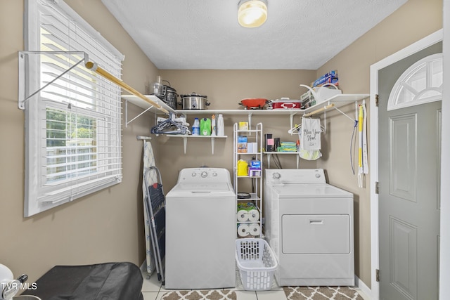 laundry room featuring washer and dryer, a textured ceiling, and laundry area