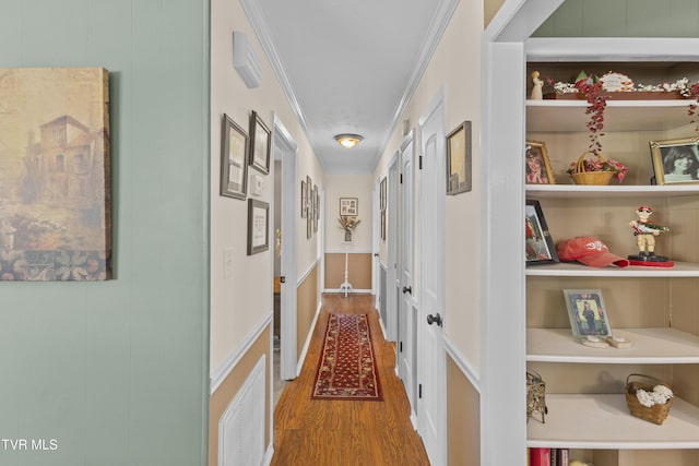 hallway featuring crown molding and wood finished floors