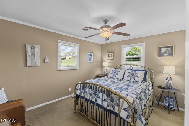 bedroom with ceiling fan, crown molding, baseboards, and carpet floors